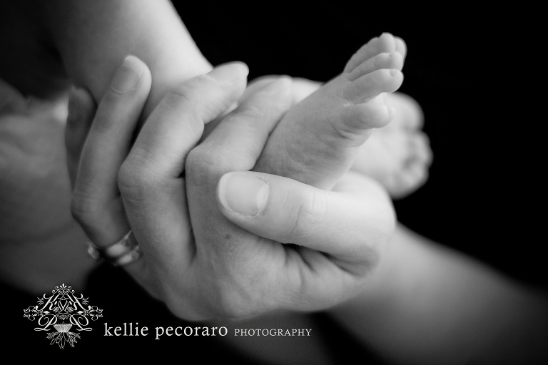 mom holding newborn's foot