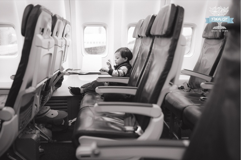 toddler sitting in airplane