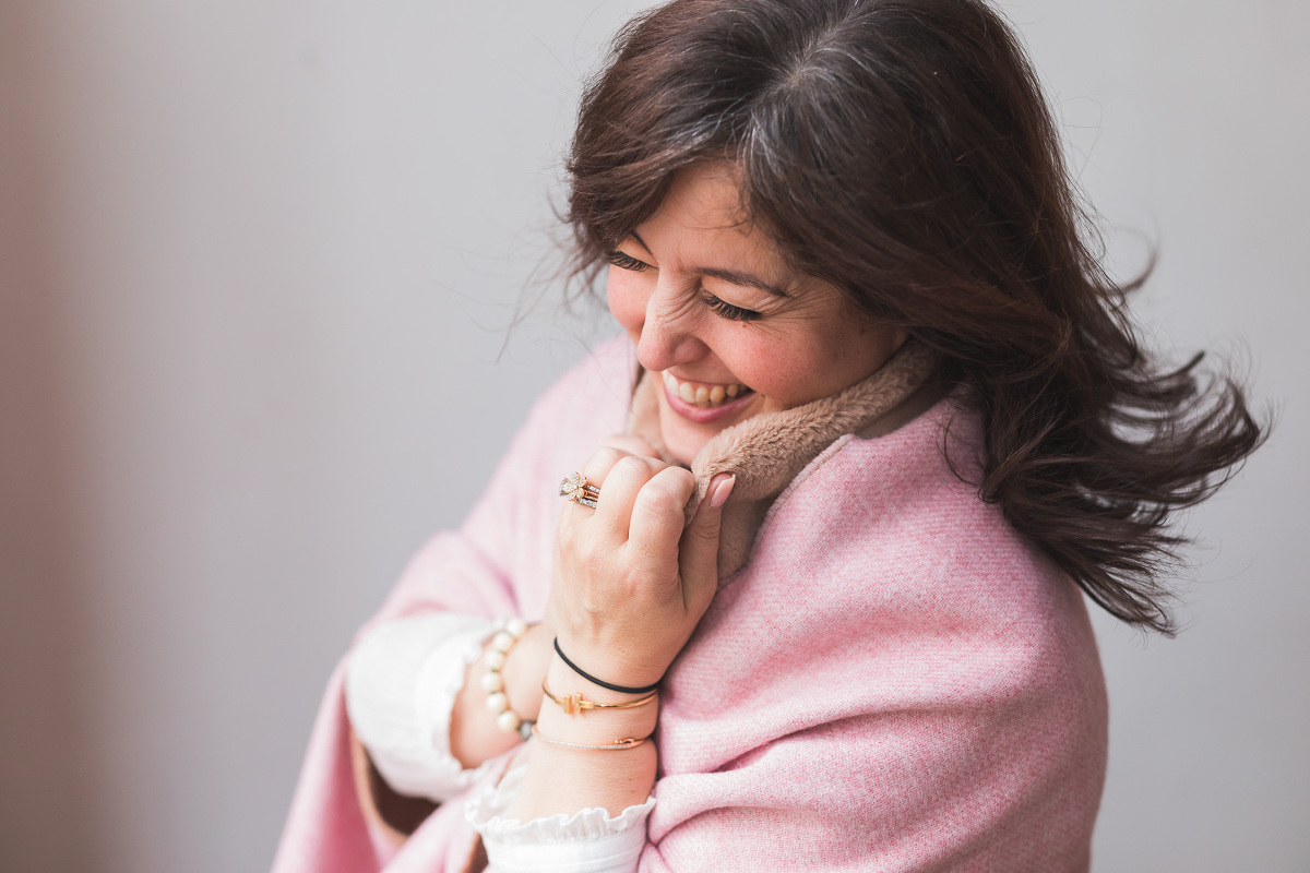 woman laughing holding her collar